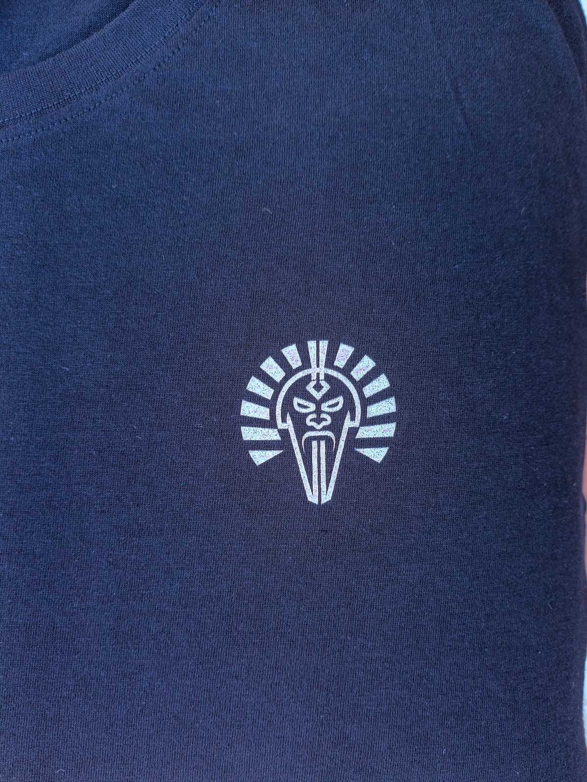 Close-up Ignis Veritas emblem on black T-shirt by B. Josephson